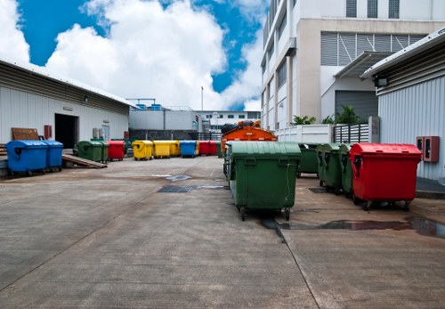 Workers sorting recyclable materials into designated bins and recycling streams